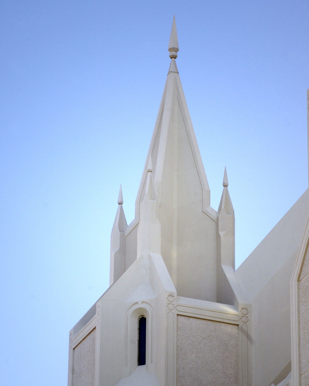 A small ornamental spire at the base of one of the temple's twin towers.