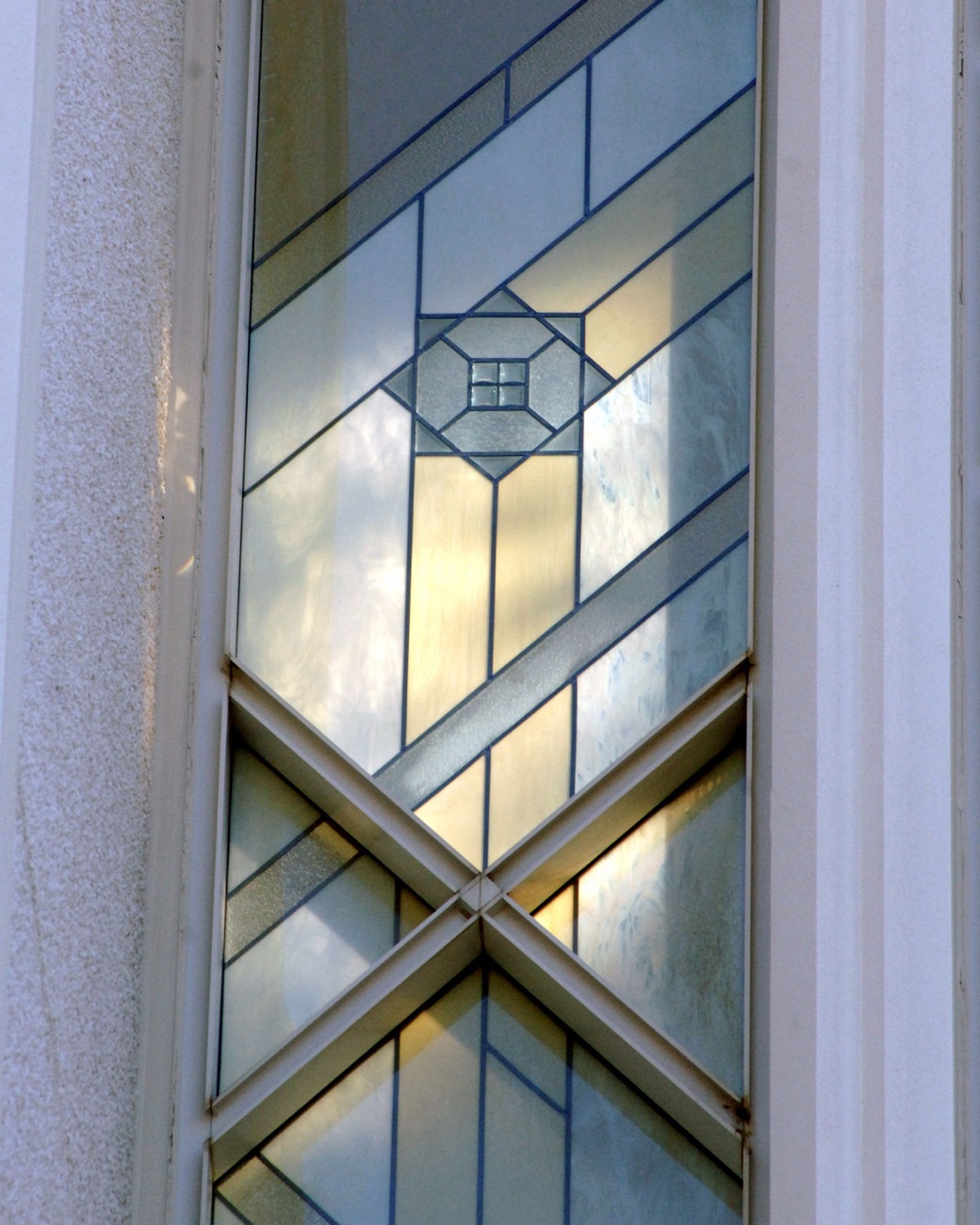 Morning light on the geometric leaded-glass windows of the temple.